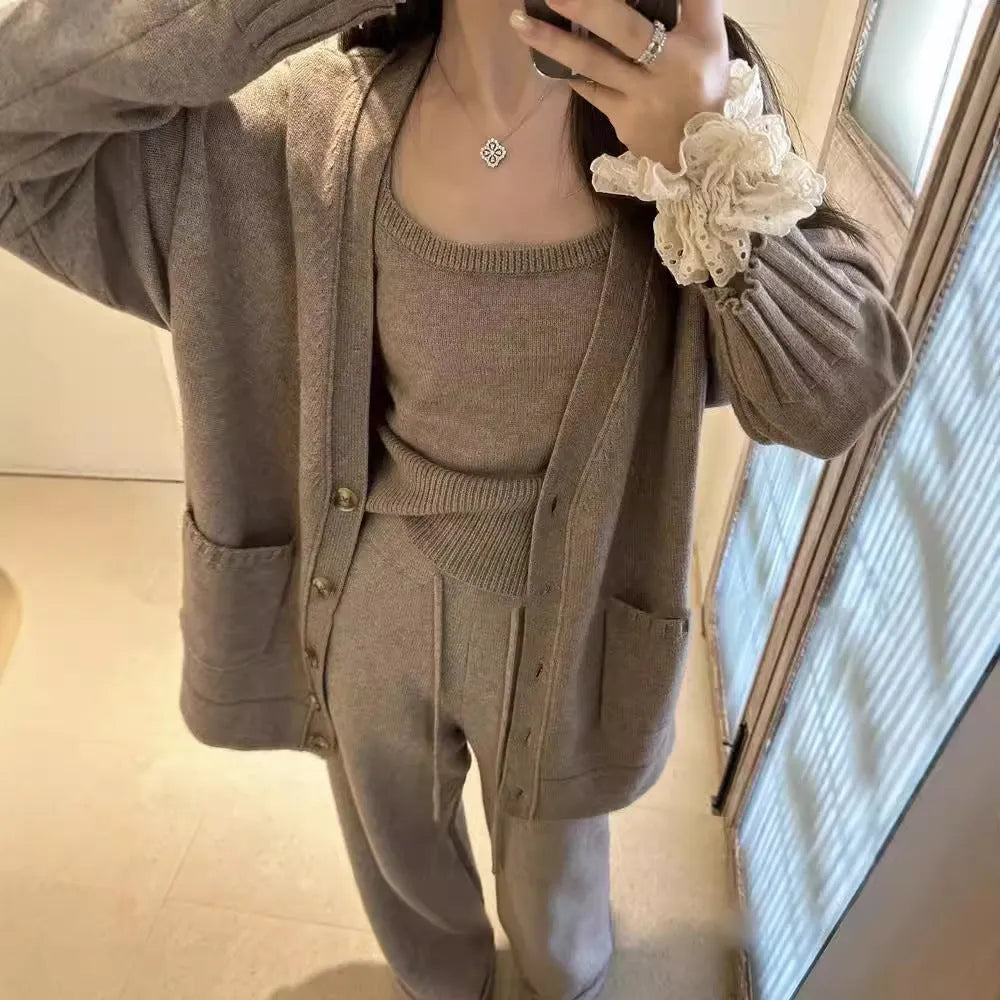 Women's loose-fit knit cardigan, vest, and trousers three-piece set in wool blend fabric.