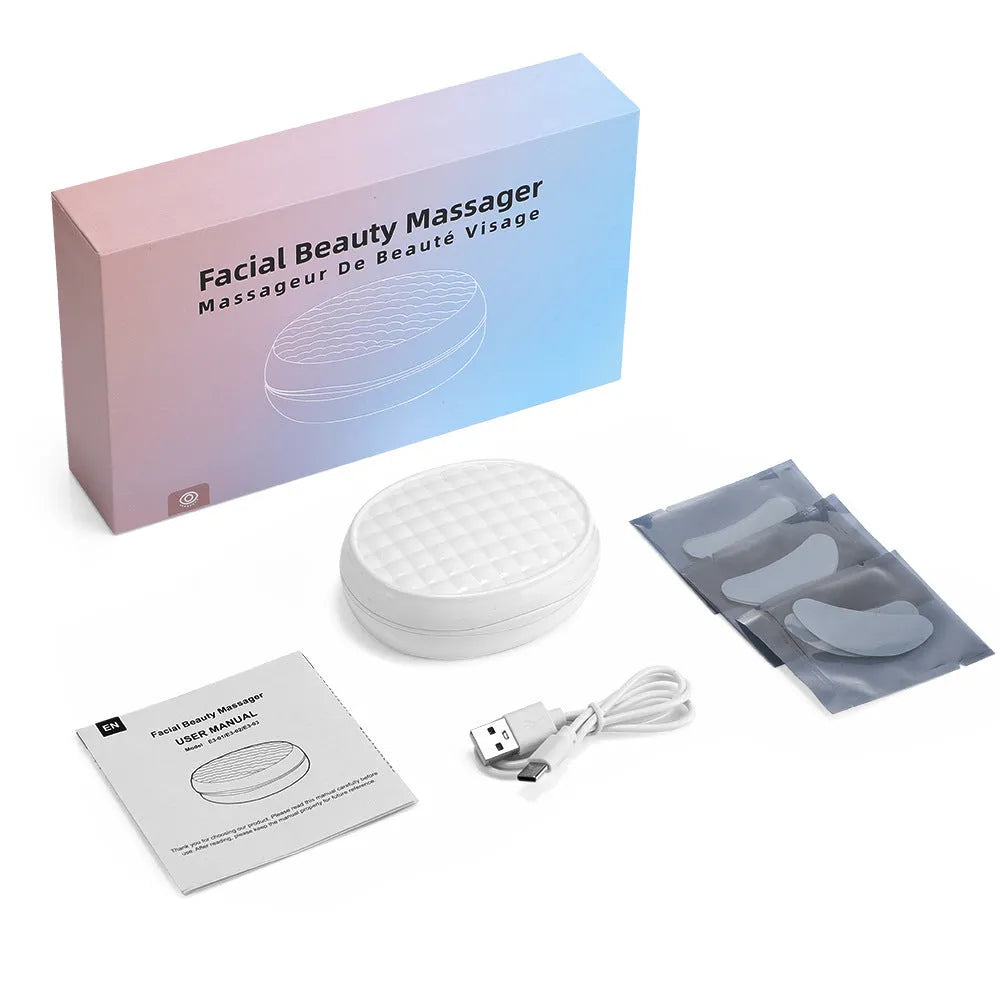 White wireless red light EMS facial and eye massage beauty device on a clean background.