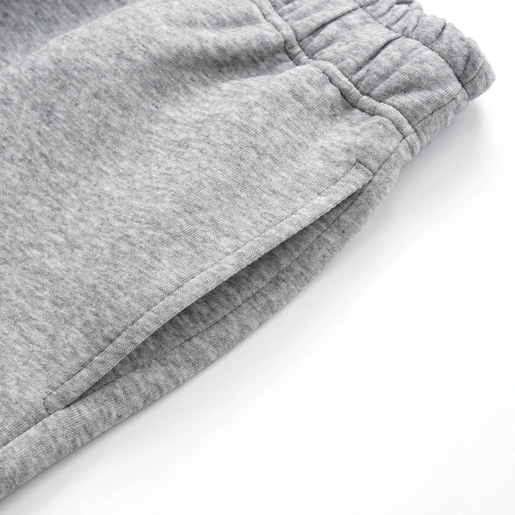 Men's straight-leg cotton trousers in black or grey with wide-leg cut and mid-waist design