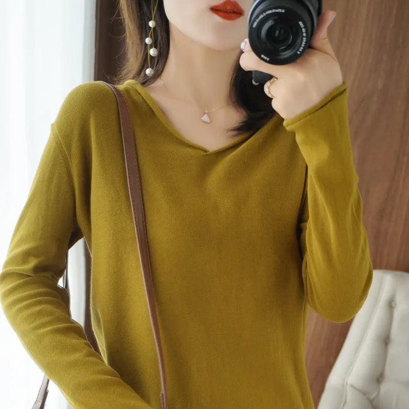 Women's V-neck long sleeve knitwear top in turmeric colour on a hanger