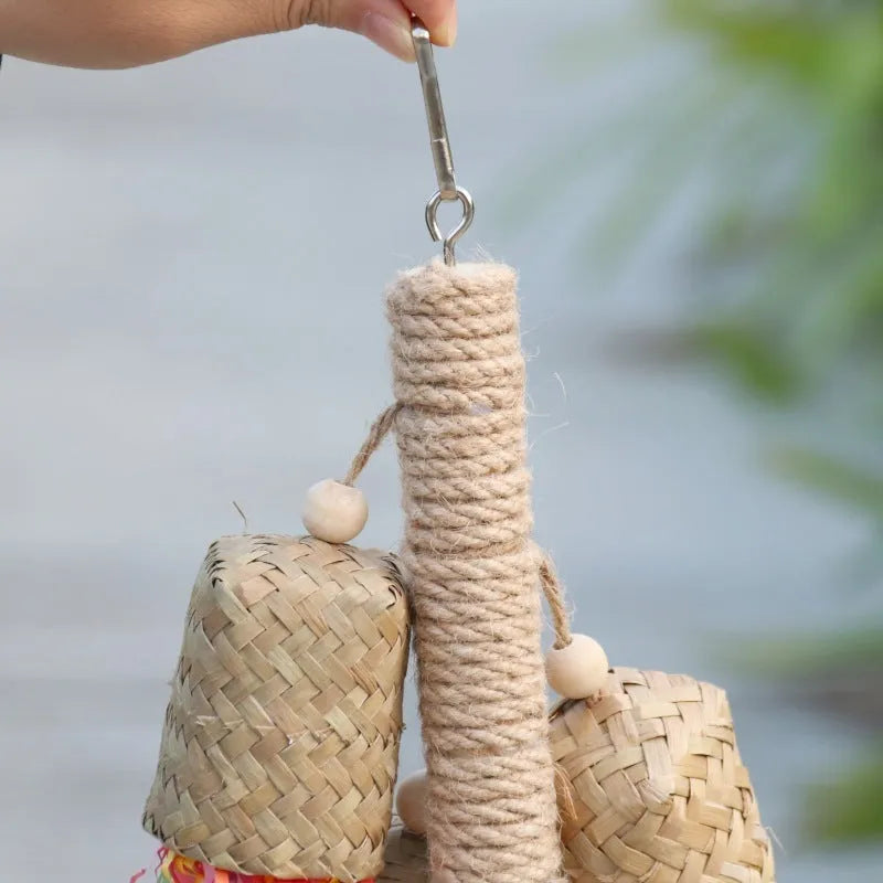 Colourful shredded paper parrot toy on wooden perch with sisal rope attachments