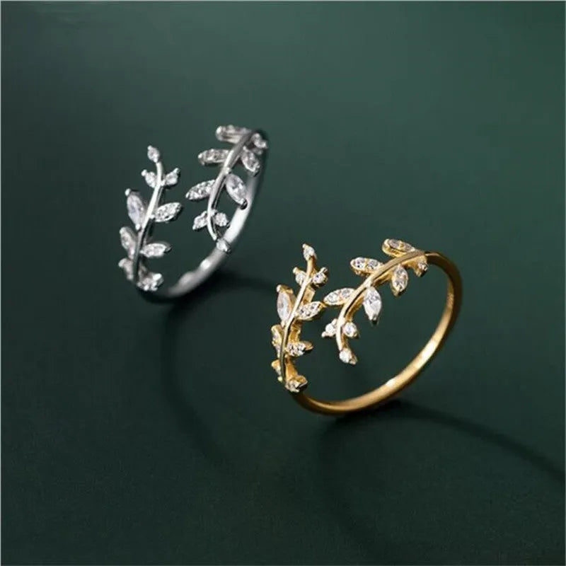 A geometric copper leaf-shaped ring for women, shown in both gold and silver electroplated finishes.
