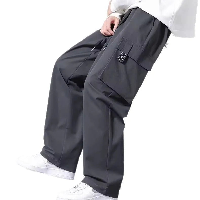 Boys in army green straight leg cargo pants with large pockets and a drawstring waist.