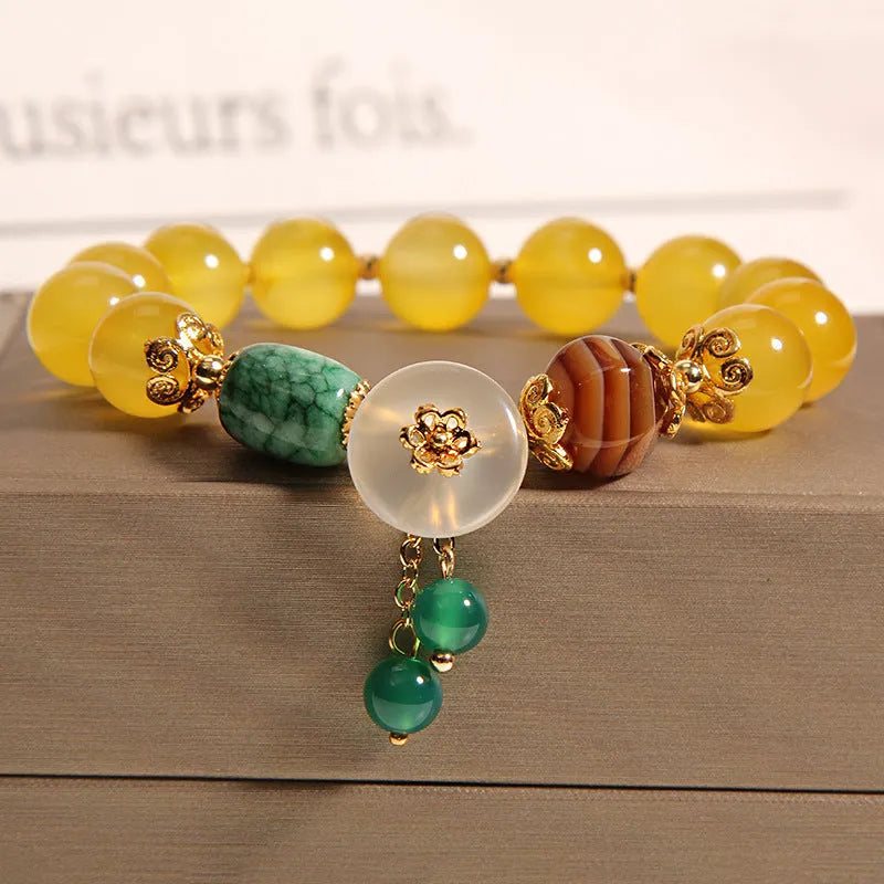 Women's yellow agate crystal bracelet on adjustable gold silk cord.
