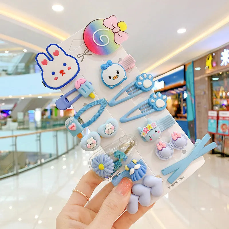 14 colourful toddler hair clips with candy, rainbow and butterfly designs and ribbon-wrapped backs