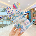 14 colourful toddler hair clips with candy, rainbow and butterfly designs and ribbon-wrapped backs
