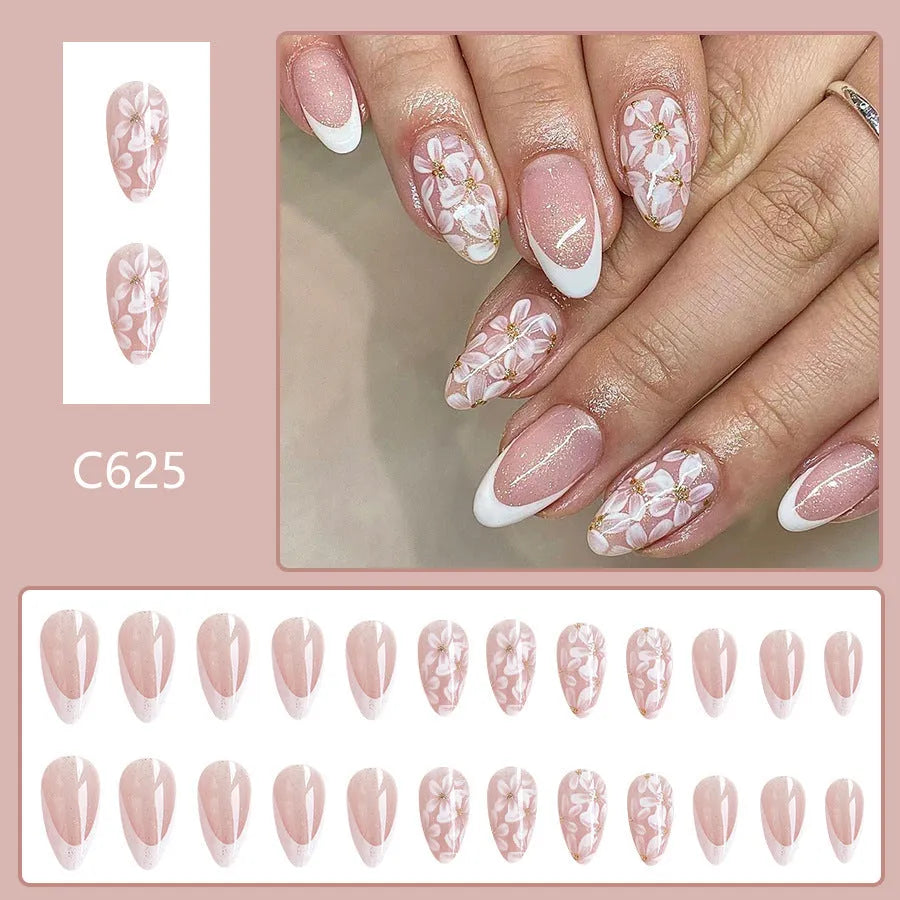 Short almond-shaped glossy French style press-on nails with removable glitter powder flower decorations, colour C625