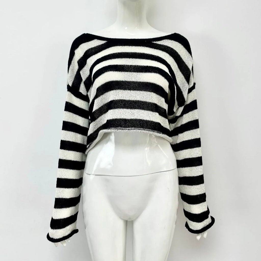 Black and white striped long-sleeved sweater worn as a pullover with an exposed navel style detail.