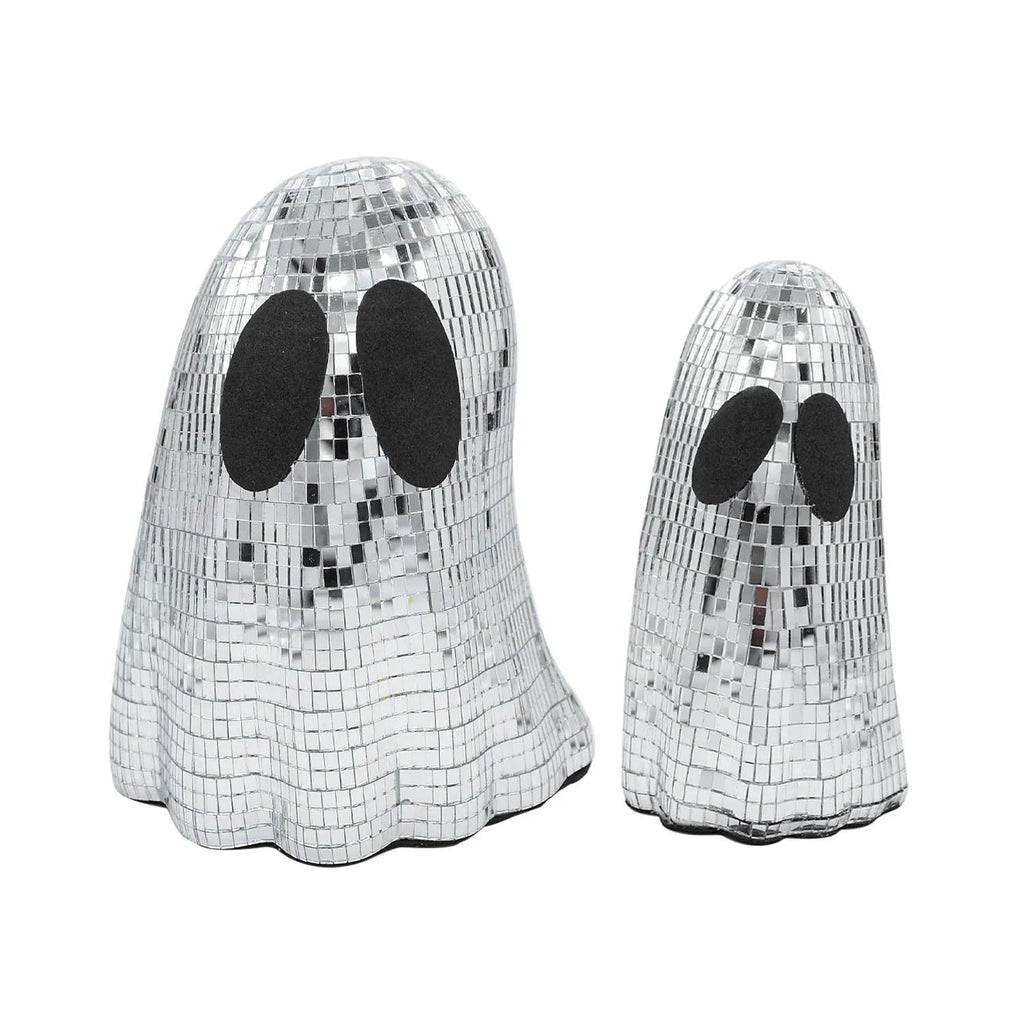 Silver glass ghost decoration with mosaic mirror patch on a desktop for Halloween.