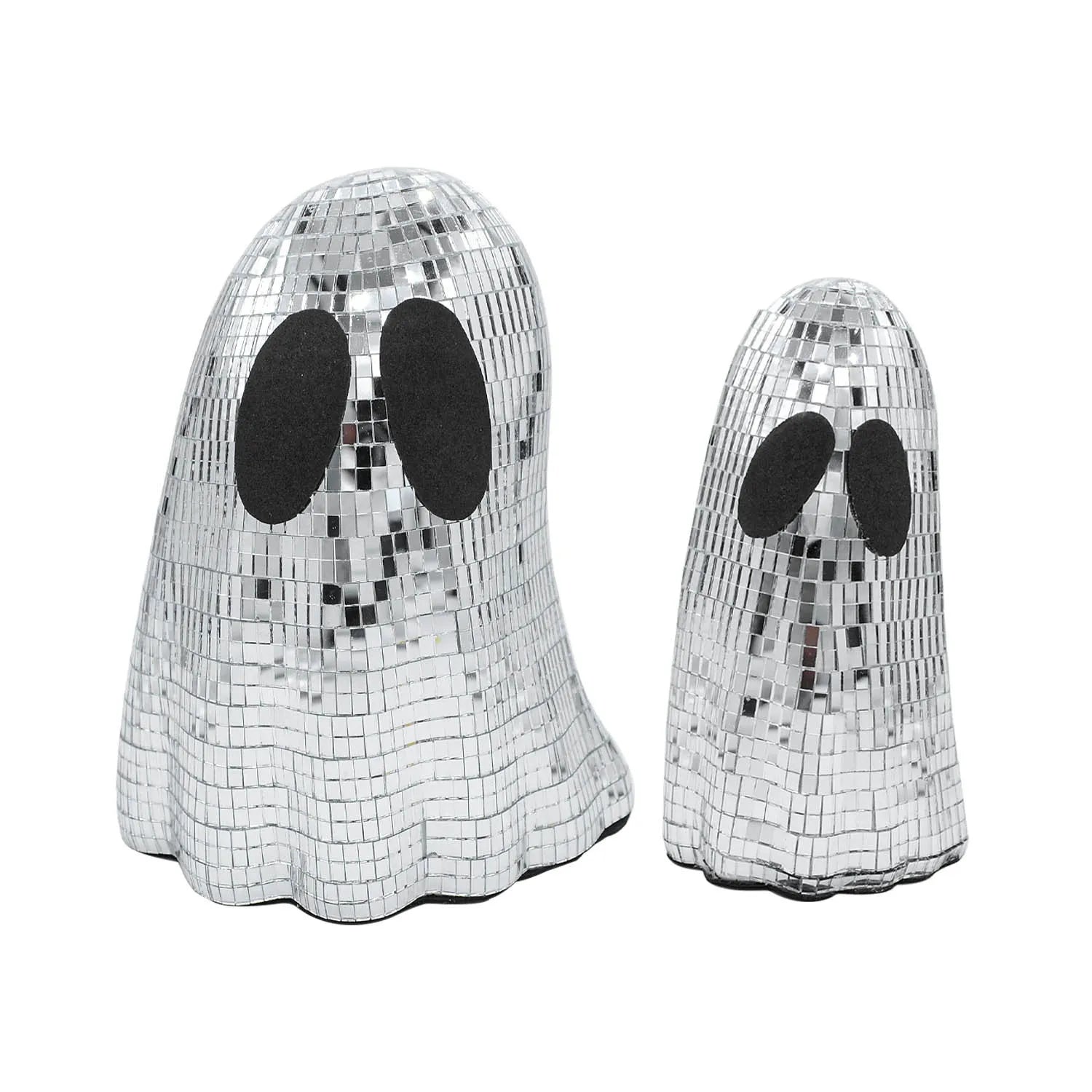 Silver glass ghost decoration with mosaic mirror patch on a desktop for Halloween.