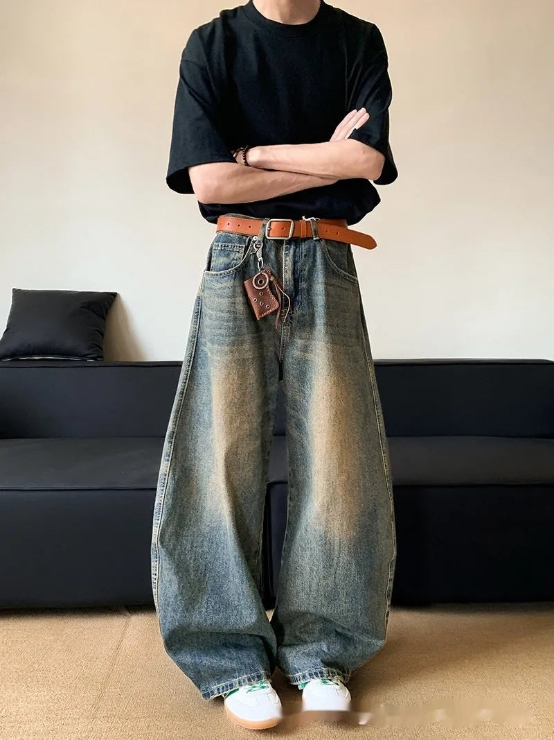 Men's retro blue distressed denim wide-leg trousers showing slim fit and vintage detailing