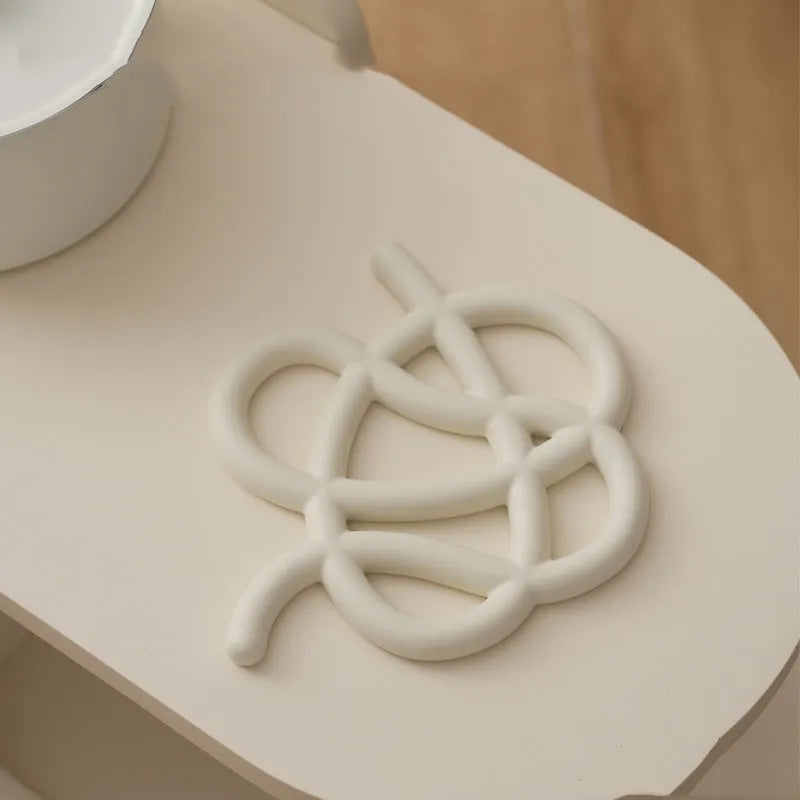 Ceramic heat proof mat with irregular shape on dining table