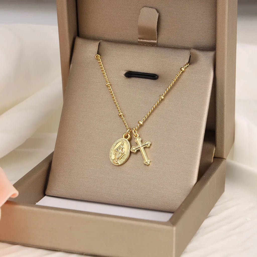Gold geometric cross necklace with Virgin Mary ornament on chain