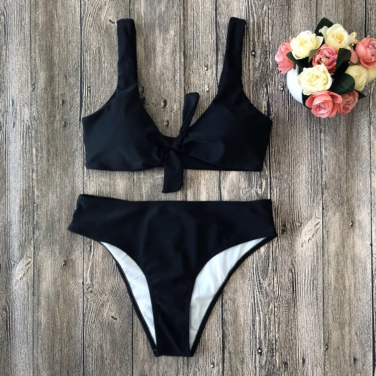 Women's solid colour bikini swimsuit set in polyester, showing sleeveless bra and matching briefs.