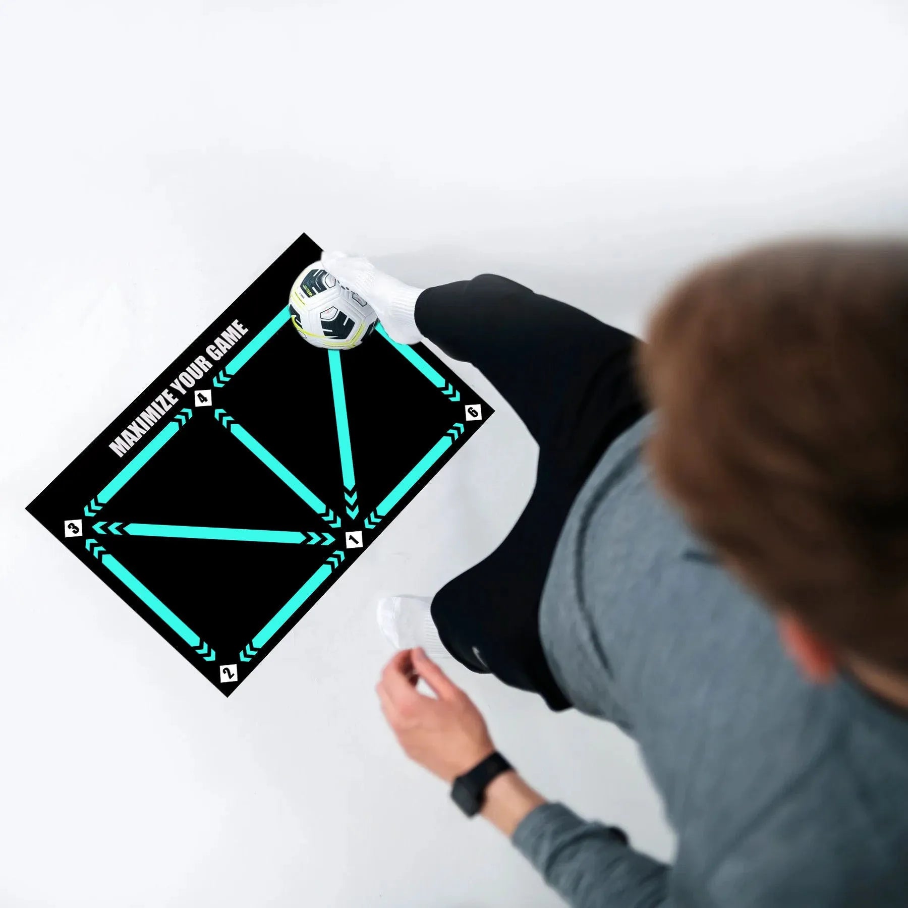 Black rectangular football training mat measuring 60cm by 90cm with a non-slip base for practice drills.