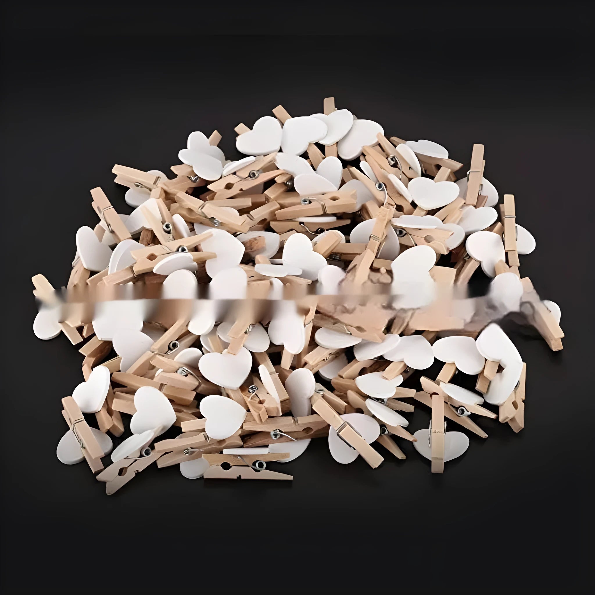 A set of five handmade wooden heart-shaped clips in assorted colours on a plain background.