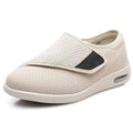 Beige wide-fit leisure shoes with velcro strap and rubber foam sole on a neutral background.