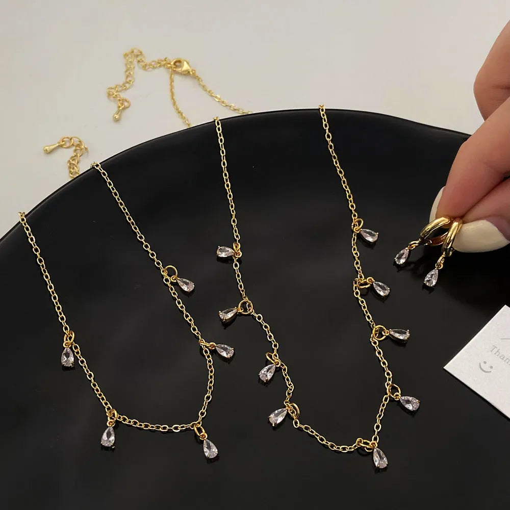 Women's zircon jewellery set showing necklace, earrings and anklet with geometric meteor shower design
