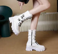 Women's black mid-calf knight boots with side zip and metal buckle details on artificial PU upper