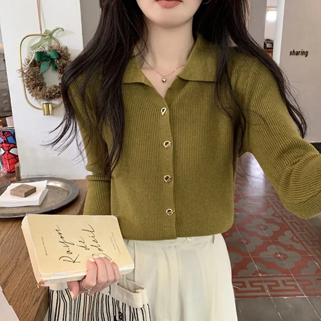 Long-sleeved beige viscose knitted cardigan top shown loose fit on a hanger
