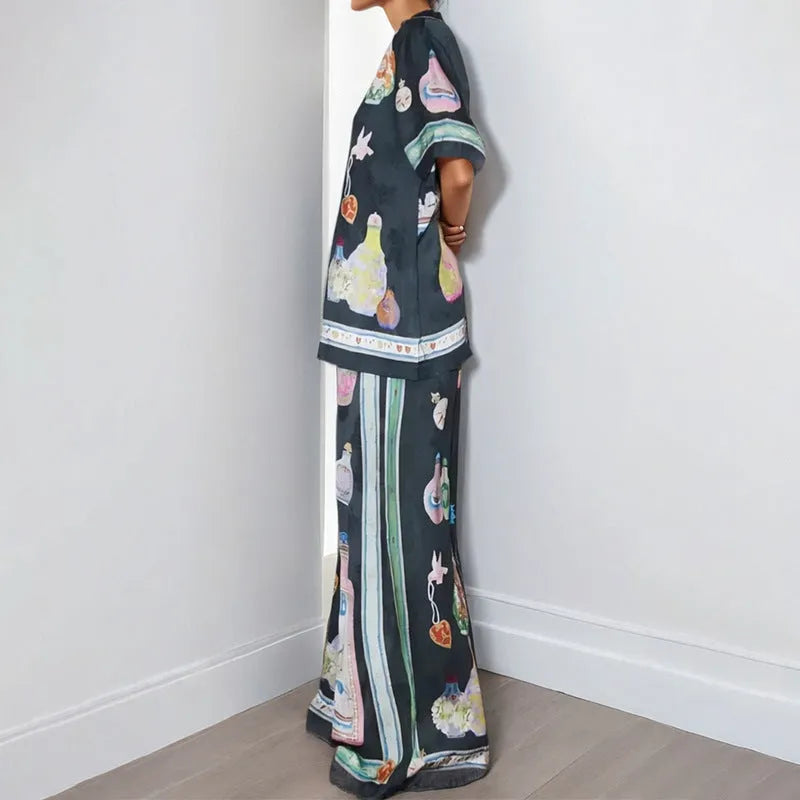 Women's black casual two-piece set with cartoon animation print, cardigan sleeve top, and matching trousers