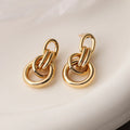 Geometric gold earrings with irregular design elements on copper base with gold electroplating