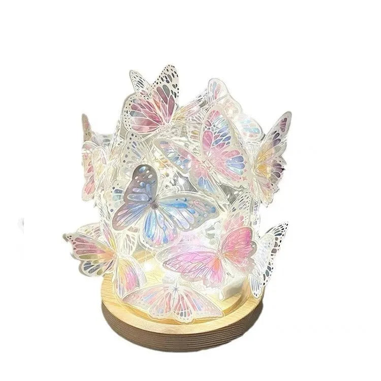 Butterfly-shaped night lamp with glass shade on raw wood base, measuring 12x15cm