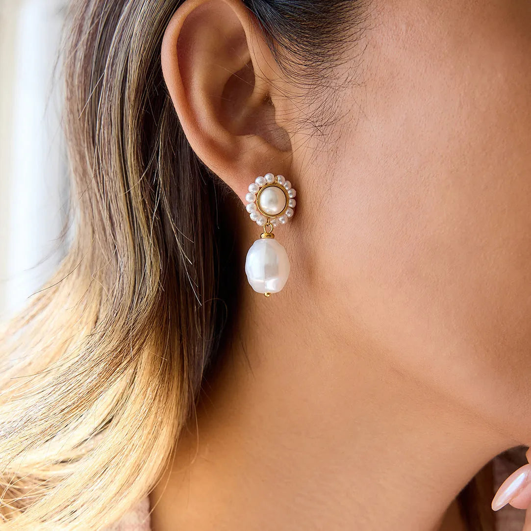 Women's stainless steel pearl ear studs with geometric ellipse shape and electroplated silver-tone finish