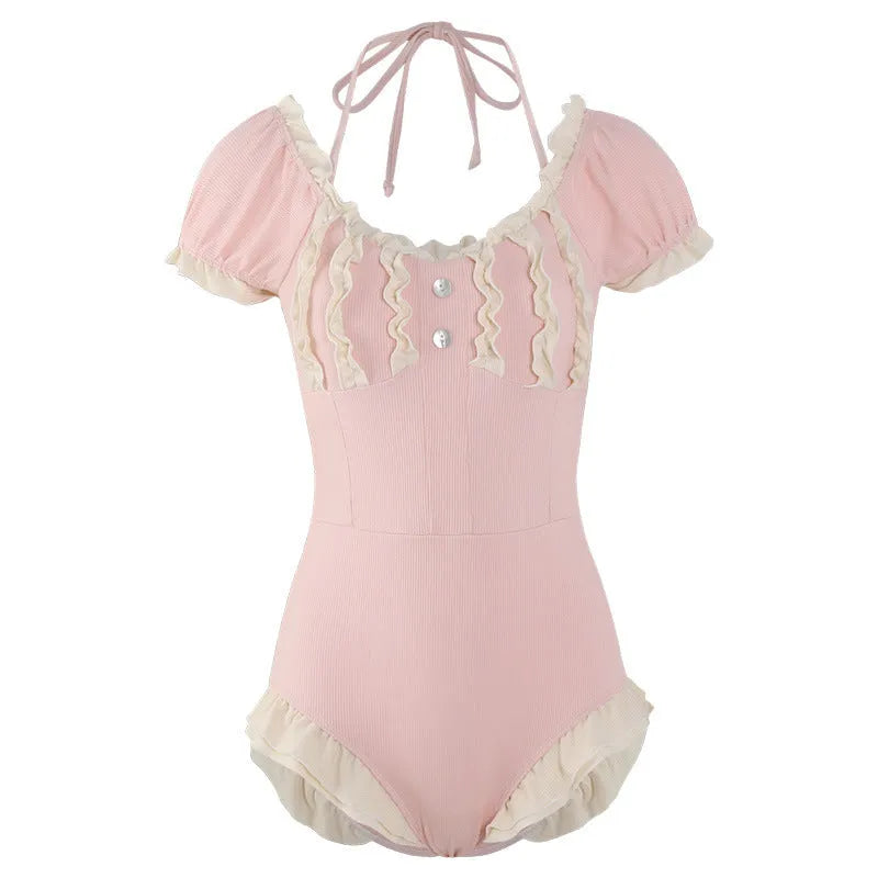 Pink women's one-piece swimsuit with conservative cut and Siamese cute design on a hanger.
