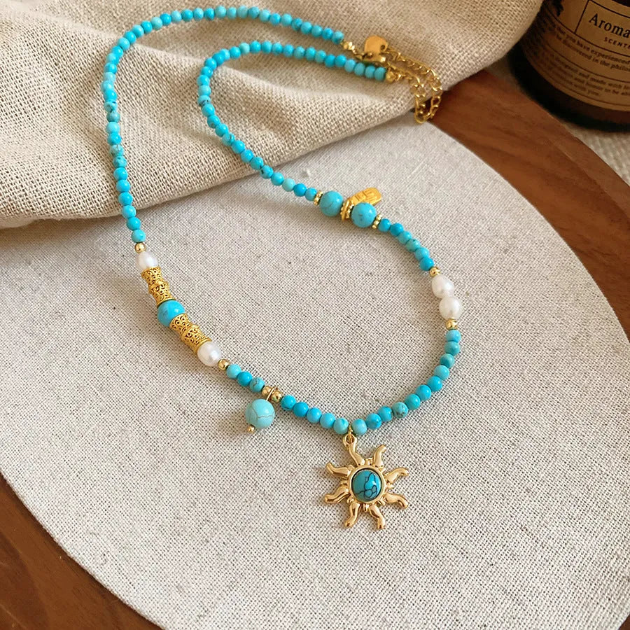 Freshwater pearl necklace with stone sun pendant in blue-sun colour option, court style geometric design