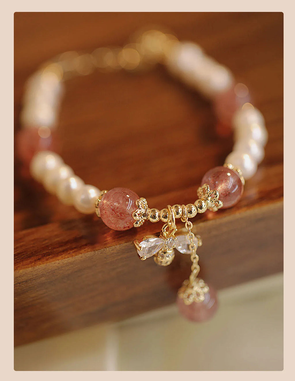 Women's strawberry quartz crystal bracelet with bow detail on wrist