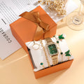 Gold green square women's watch with four matching butterfly bracelets on white background