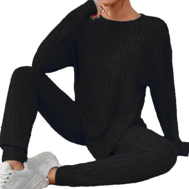 Black sunken stripe two-piece homewear set with pants and regular sleeve top on hanger