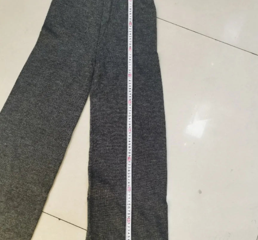 Women's acrylic knit sweater suit with side-slit top and matching trousers in dark grey