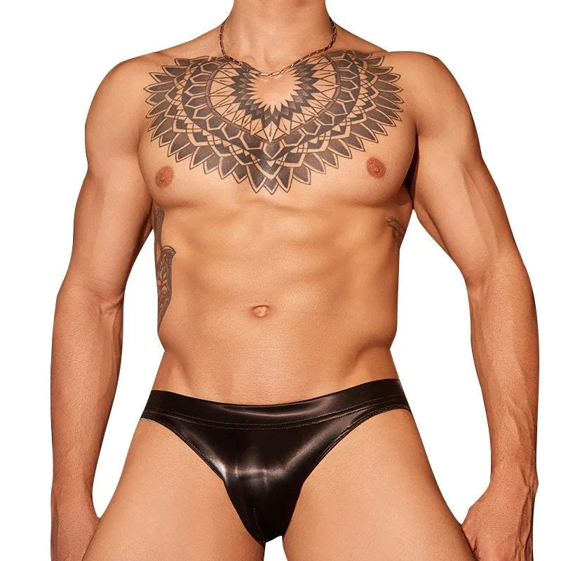 Men's black shark skin lace briefs with small hip cut on a white background.