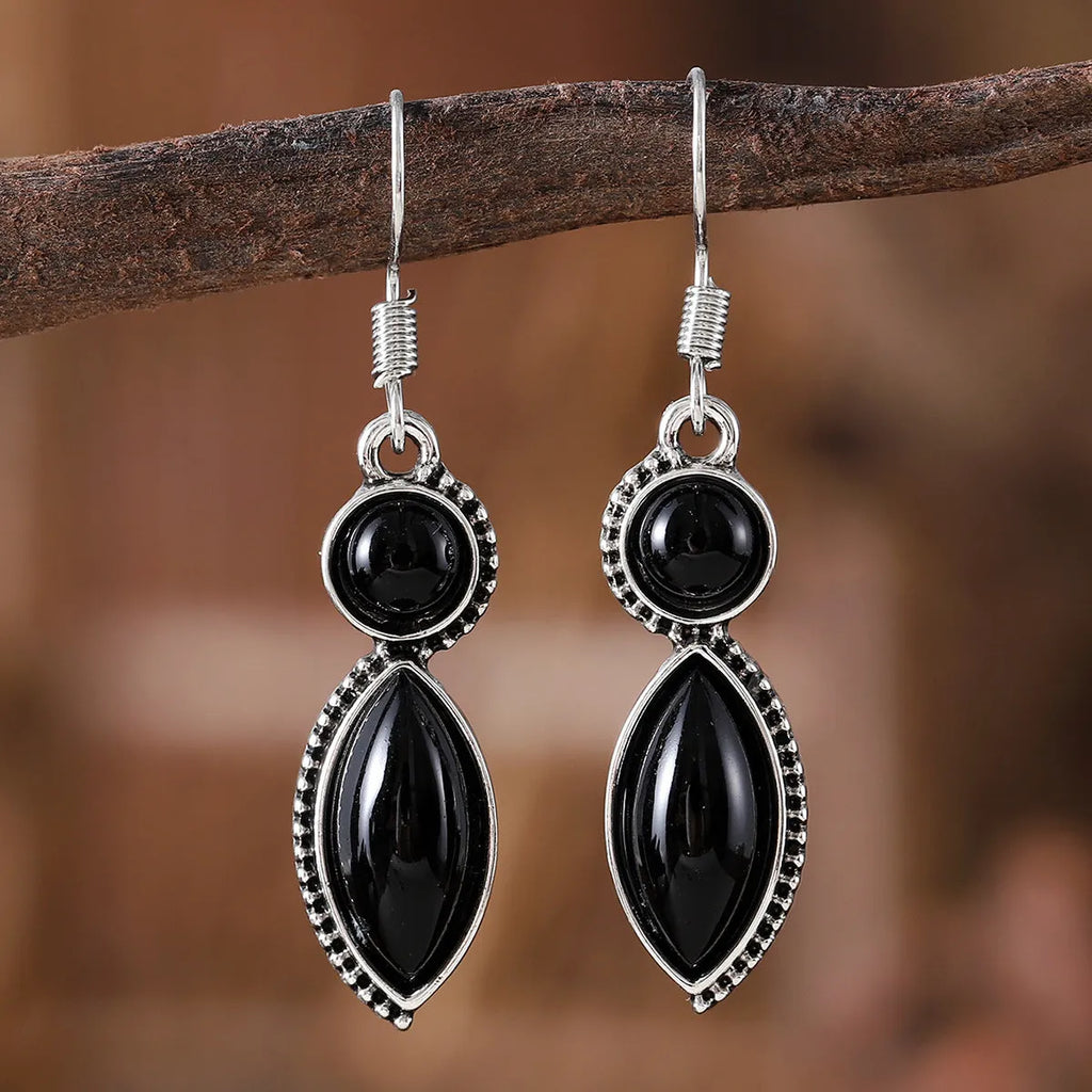 Pair of vintage geometric pendant earrings in black and purple zinc alloy with round retro design