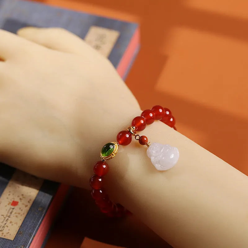 Chinese style women's bracelet with natural amber, red agate beads and gold Buddha charm