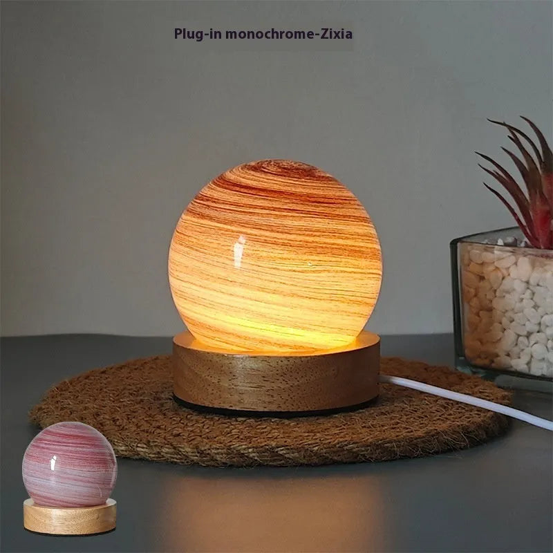 Planet-themed USB night light with modern design and three-colour dimming on included base