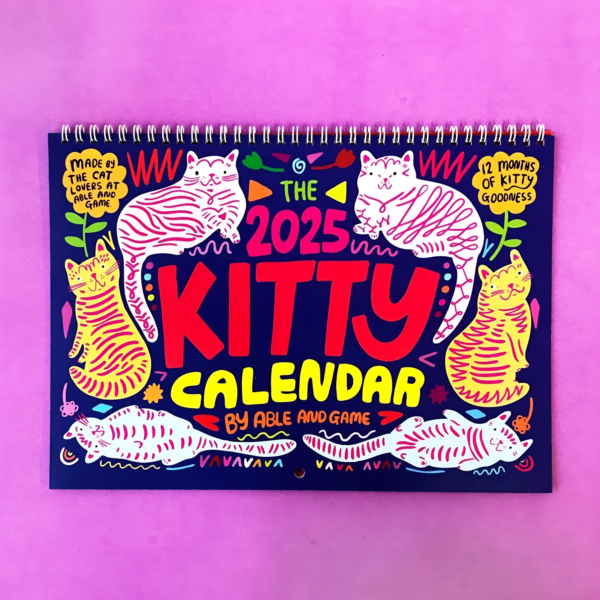 Cat-themed wall calendar with monthly date grid on paper for 2024 or 2025 planning