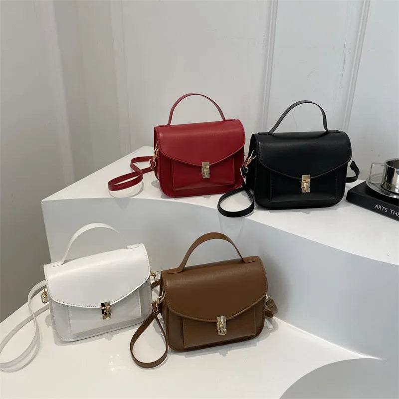 Shoulder messenger bag in horizontal square shape with sewing line detailing and crossbody strap