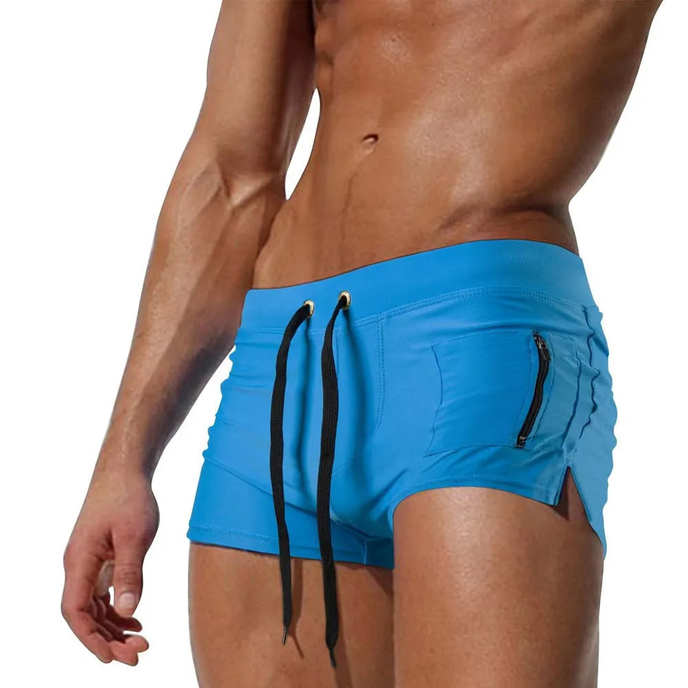 Men's black high waist swimming trunks with a front lace-up closure, shown on a model.