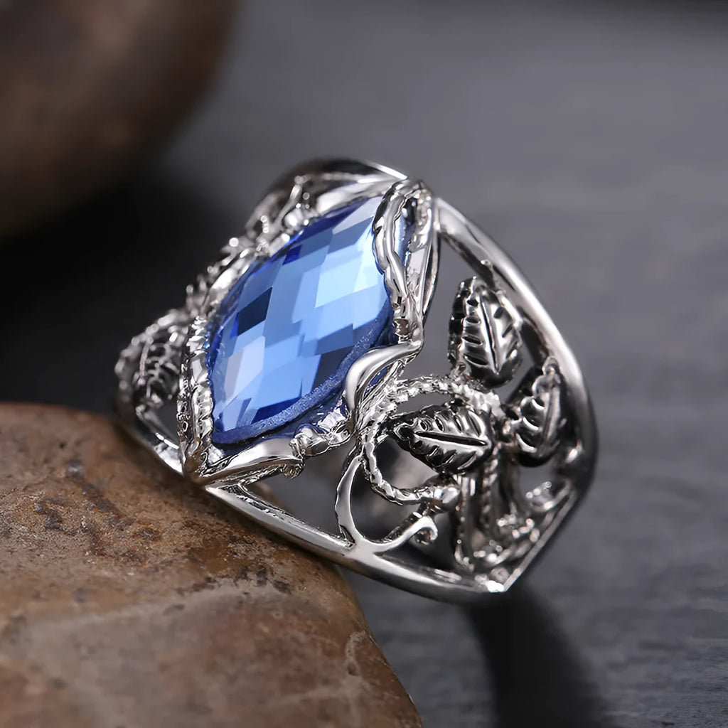 Women's horse eye-shaped blue crystal alloy ring on a hand, showing geometric design.