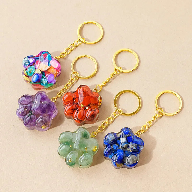 Cat's paw shaped keychain pendant made from a natural crystal gemstone on a keyring.