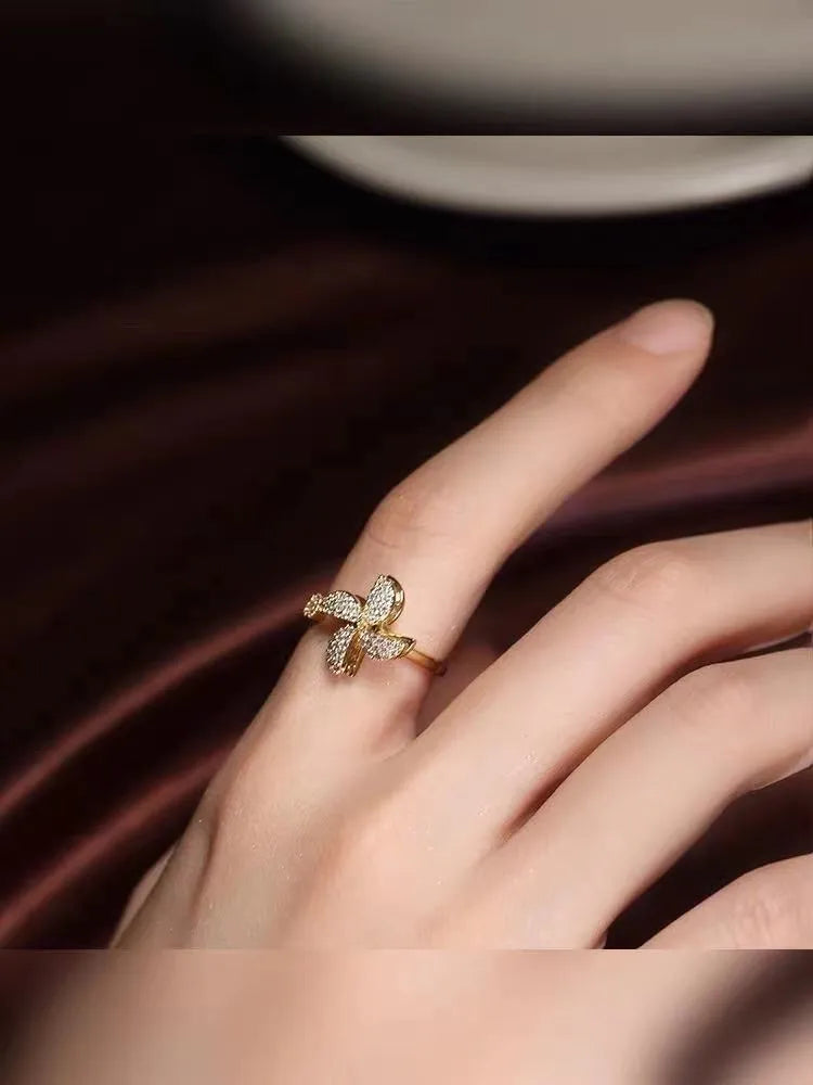 Rotating ring with spinning windmill design and micro inlaid geometry pattern in gold electroplated finish
