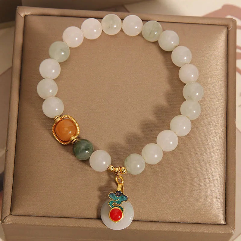 Women's ice jade crystal bracelet with pearl accents and a Xiangyun jade buckle on a white background.