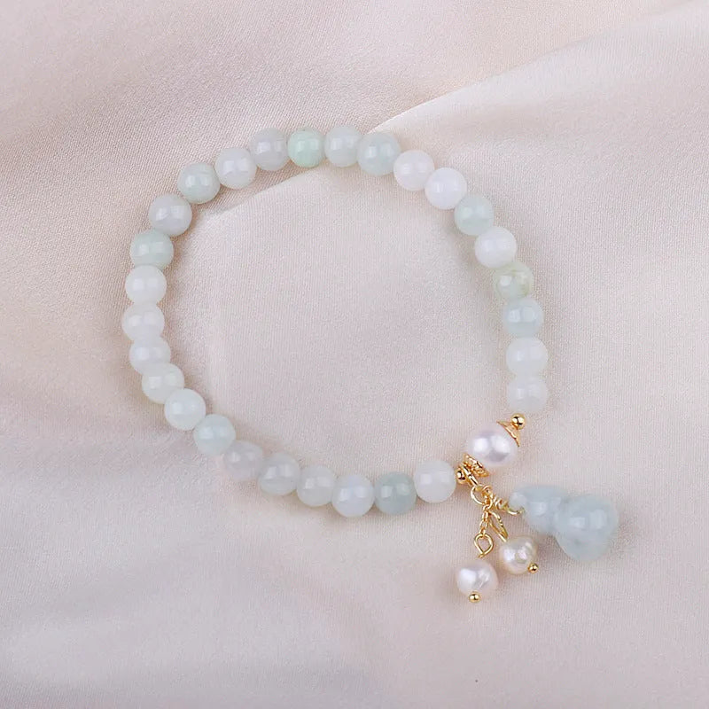Emerald jade bracelet with hand-carved gourd design in traditional Chinese style