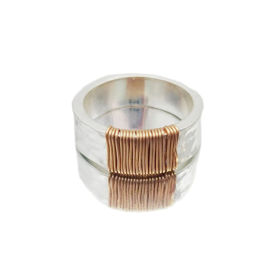 Geometric wide face copper bracelet ring with irregular coil design in silver gold finish.