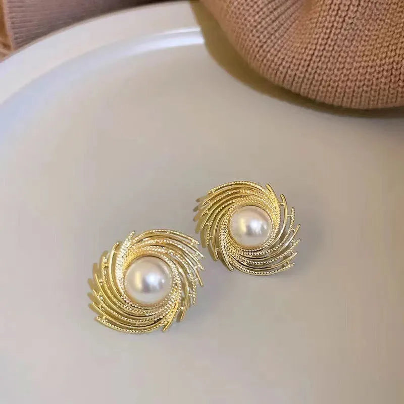 Vintage style earrings with simulated pearl drops in irregular flower shape design