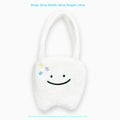 White large tote bag with plush large tooth shoulder strap and cute teeth design