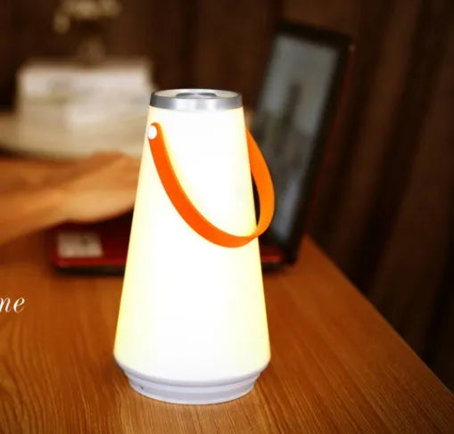 White rechargeable LED table lamp with adjustable brightness settings measuring 12x12x22cm